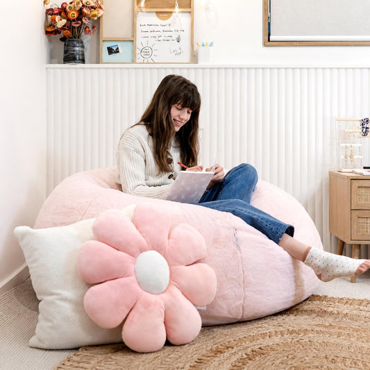 Soft pink plush bean bag with large flower bolster and white center