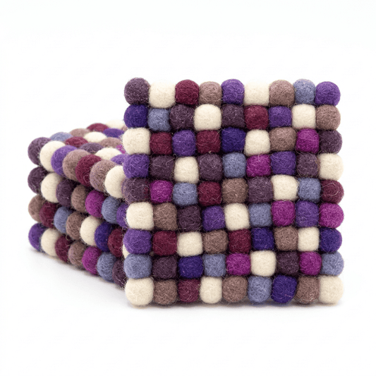 Round wool felt coaster set with checkered pom‑pom pattern in purple, plum, and cream