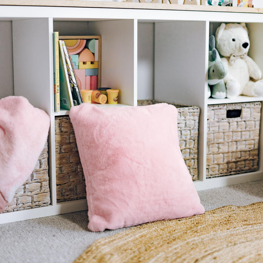Soft pink plush fur cushion cover with insert, square pillow on floor