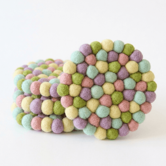 Pastel rainbow wool-felt coaster with raised ball texture, set of four.