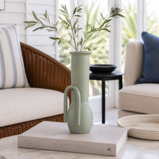 Sage green ceramic vase with cutout loop handle, tall slender shape