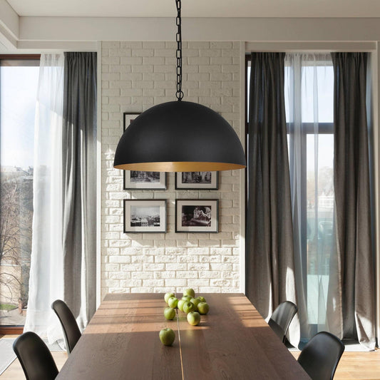 Black dome pendant light with chain and warm gold interior shade.