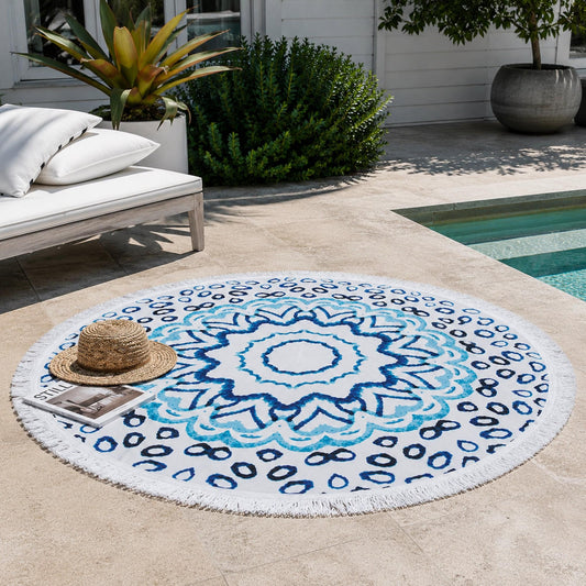 Round beach towel with blue watercolor medallion and dotted ring pattern on white.