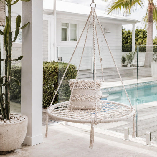 Cream round hanging hammock swing with macrame seat and hanging rope frame