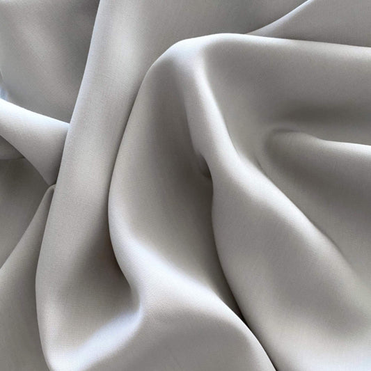Light gray silky bamboo sheet fabric close-up with smooth drape