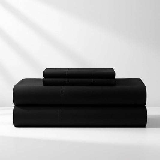 Black king sheet set with folded top and bottom sheets, neatly stacked