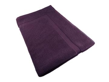 Burgundy cotton bath mat, folded edge view, soft terry loop texture