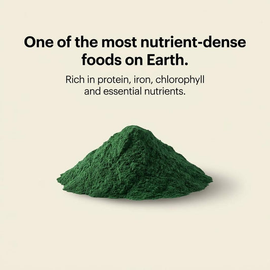 Green freeze-dried spirulina powder mound, dark green granules in a heap.