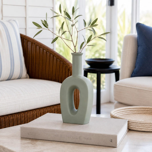 Sage grey ceramic tulip vase with oval cutout and narrow neck.