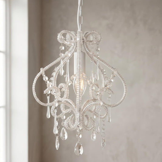White chandelier with ornate scrollwork and dangling crystal-style drops